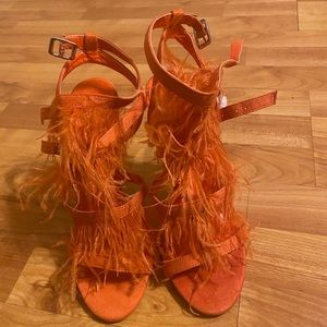 Orange heels with feathers